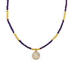 Necklace with purple beads and charm